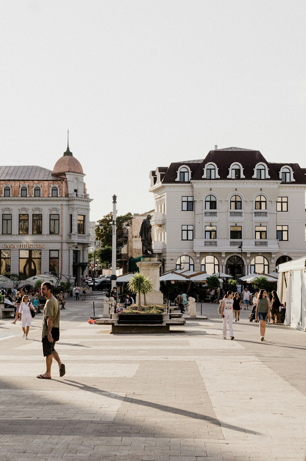 Pedestrians crossing a busy downtown plaza in a Canadian city